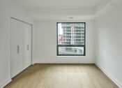Thumbnail 19 of 46 - an empty room with a large window and white walls