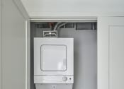Thumbnail 38 of 46 - a white washer and dryer in a white closet
