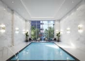 Thumbnail 1 of 59 - a swimming pool in a room with marble walls - rental amenities