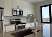 Thumbnail 21 of 21 - a kitchen with a sink and a microwave