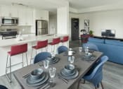 Thumbnail 1 of 21 - a kitchen and living room with a dining table and chairs
