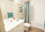 Thumbnail 6 of 11 - a bathroom with a sink and a toilet and a shower