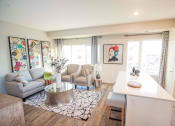 Thumbnail 5 of 11 - a living room with a couch and a table