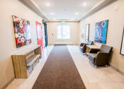 Thumbnail 9 of 11 - a hallway with chairs and paintings on the wall and a carpet