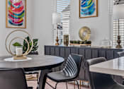 Thumbnail 5 of 19 - A modern dining room with a round table and chairs.