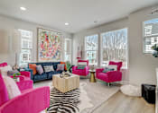 Thumbnail 5 of 38 - A living room with a zebra rug and a pink chair.