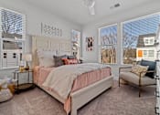 Thumbnail 4 of 19 - A bedroom with a large bed and a window with blinds.
