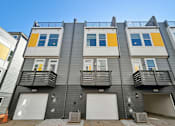 Thumbnail 19 of 19 - A row of modern townhouses with balconies and garages.