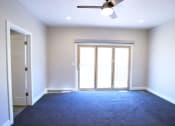 Thumbnail 21 of 26 - Spacious Bedroom With Carpeted Flooring, Fan and Light Fixture, and Plenty of Natural Light at Moenave Townhomes in Springdale, Utah