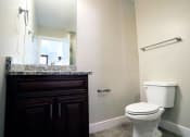 Thumbnail 20 of 26 - Downstairs Bathroom With Mirror, Marble Counters, Light Fixture, and Toilet at Moenave Townhomes in Springdale, Utah