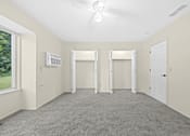 Thumbnail 19 of 23 - Empty room with a ceiling fan and three doorways.