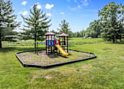 Thumbnail 5 of 22 - A playground with a yellow slide and a red roof.