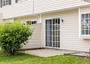 Thumbnail 7 of 22 - A house with a grey siding and a white window.