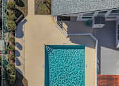 Thumbnail 6 of 19 - A rectangular pool with a concrete floor and a concrete wall surrounding it.