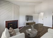 Thumbnail 11 of 15 - a living room with a fireplace and a tv