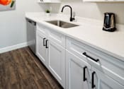 Thumbnail 9 of 15 - the preserve at ballantyne commons apartment kitchen with sink and white cabinets