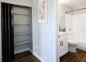 Thumbnail 8 of 15 - a bathroom with a closet and a toilet and a sink