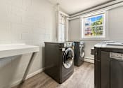 Thumbnail 35 of 51 - A laundry room with a washer and dryer.