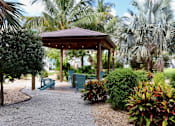 Thumbnail 13 of 23 - A gazebo surrounded by greenery and trees.