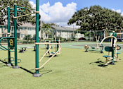 Thumbnail 22 of 24 - A playground with green equipment and a green fence.