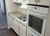 Thumbnail 8 of 10 - White kitchen cabinets with luxury vinyl planking