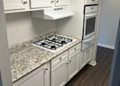 Thumbnail 9 of 10 - White kitchen cabinets with luxury vinyl planking