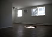 Thumbnail 47 of 51 - an empty living room with wood floors and a window