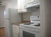 Thumbnail 50 of 51 - a kitchen with white appliances and white cabinets and a refrigerator