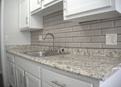 Thumbnail 44 of 51 - a kitchen with white cabinets and granite counter tops and a sink