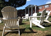 Thumbnail 41 of 51 - a group of adirondack chairs and a table in front of a building