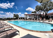 Thumbnail 12 of 56 - A large outdoor swimming pool surrounded by sun loungers.
