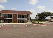 Thumbnail 9 of 56 - A building with the number 14 on it is surrounded by a parking lot.