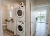 Thumbnail 31 of 56 - A white washing machine and dryer in a laundry room.