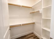 Thumbnail 33 of 56 - A white closet with shelves and a door.