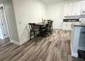 Thumbnail 26 of 56 - A kitchen with a dining table and chairs.