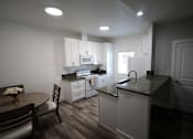 Thumbnail 29 of 56 - A kitchen with a table and chairs.