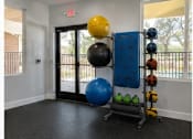 Thumbnail 56 of 56 - A room with a blue and yellow exercise ball on a stand.