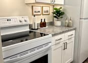 Thumbnail 1 of 11 - A white stove top oven with a black stovetop.
