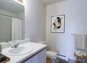 Thumbnail 7 of 11 - A bathroom with a white sink and a toilet.