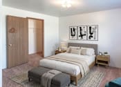 Thumbnail 6 of 11 - A bedroom with a large bed, a bench, and a chair.