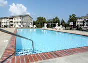 Thumbnail 9 of 11 - A swimming pool with a red brick border.