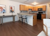 Thumbnail 3 of 13 - A kitchen with wooden cabinets and a white countertop.