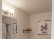 Thumbnail 10 of 14 - A bathroom with a toilet, sink, and wooden cabinets.