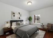 Thumbnail 3 of 9 - A bedroom with a large bed and a chair.