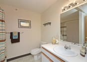 Thumbnail 12 of 21 - Bathroom with Vanity Lights at Geary Estates Apartments, MRD Conventional, Kansas