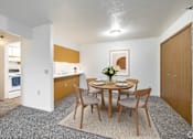 Thumbnail 9 of 14 - A dining room with a table set for two.