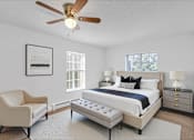 Thumbnail 6 of 17 - A bedroom with a bed, chair, and a ceiling fan.