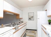 Thumbnail 6 of 11 - A kitchen with white cabinets and a sink.