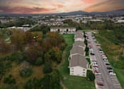 Thumbnail 8 of 20 - an aerial view of a church and a parking lot with a sunset in the background