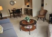 Thumbnail 21 of 22 - a living room with a couch and a coffee table